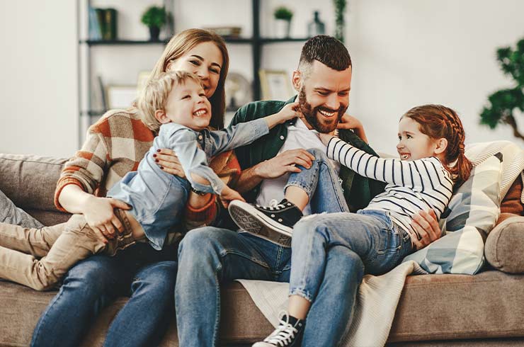 family of four on their living room couch