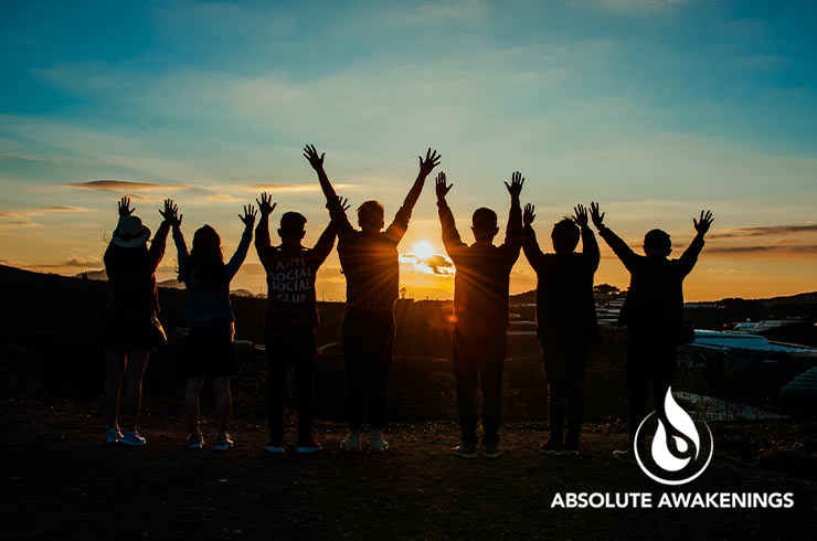 group of people outside at sunrise celebrating completing a drug rehab program