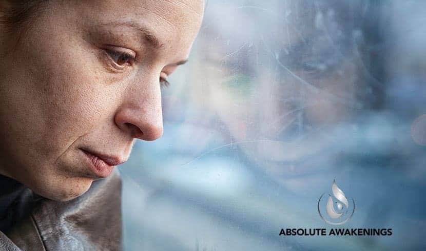 woman with anhedonia staring out of a window