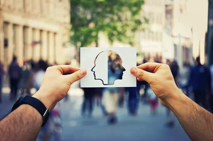 man holding up a graphic illustrating bipolar 1 and bipolar 2