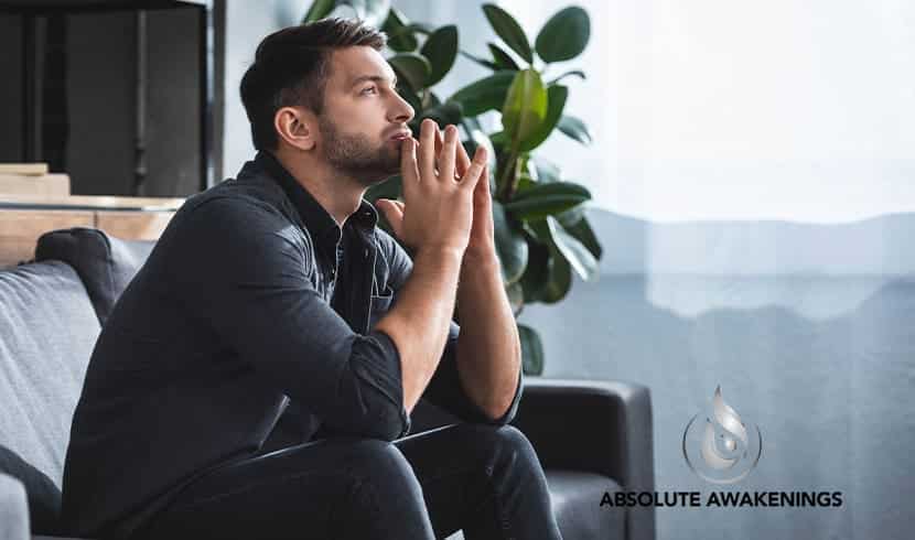 man with anxiety sitting on a couch