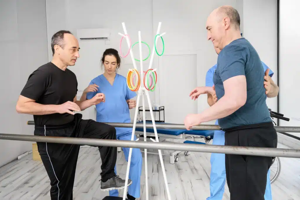 Neurorehabilitation therapy session with patients exercising under guidance of healthcare professionals