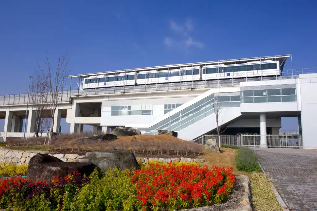 Detox center exterior with elevated train line and landscaped garden