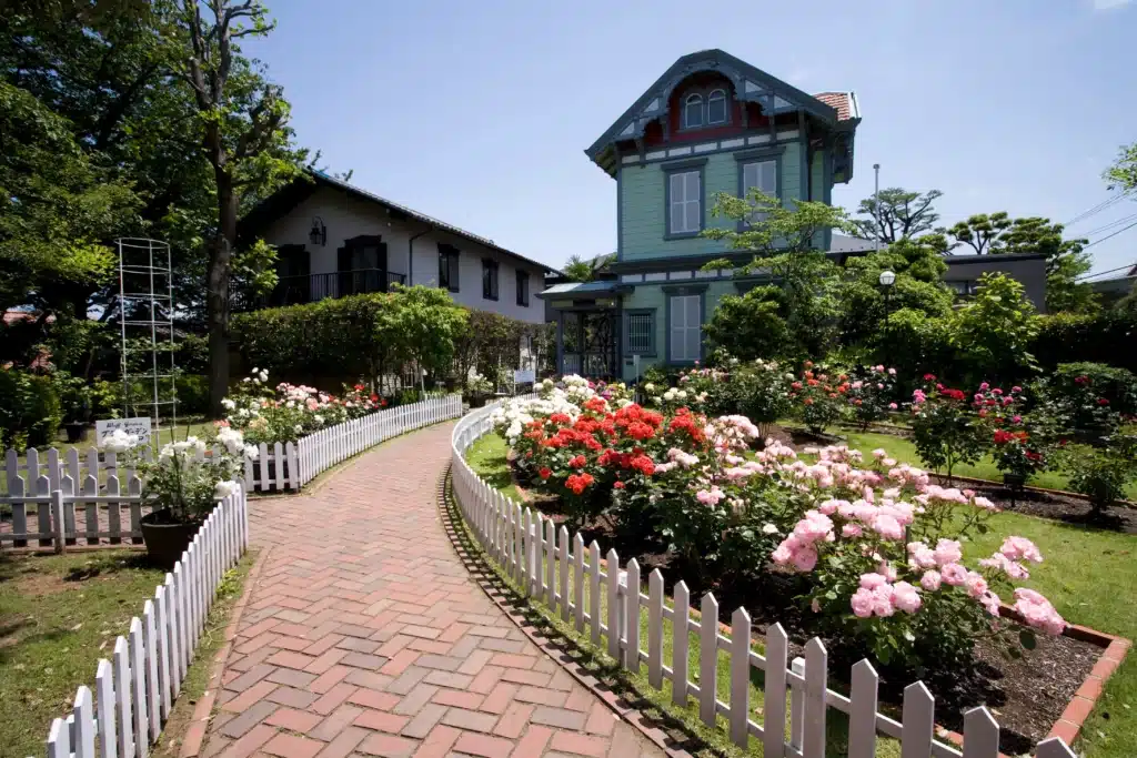 Residential rehab center exterior with garden path and white picket fence